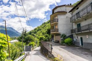 a building on a hill with mountains in the background at Casa Lena in Colorina