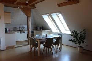 a table and chairs in a kitchen with windows at Villa Mary in Lychen