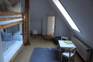 a bedroom with a bunk bed and a table and a mirror at Villa Mary in Lychen