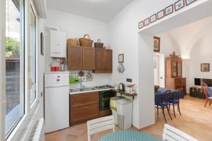 a kitchen with a white refrigerator and a table at Appartamento Anna in Meta +16 photos