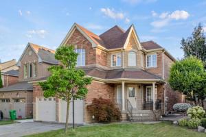 a large brick house with a roof at Cozy 1 Br Apt with TV, Workstation, Kitchenette & Parking in Mississauga