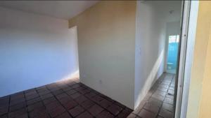 a hallway with a tile floor and a white wall at AbaHome Paiva in Cabo de Santo Agostinho