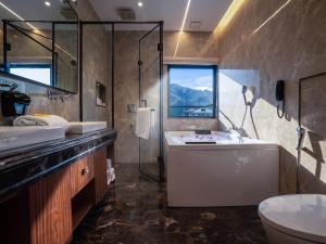 a bathroom with a tub and a sink and a shower at Solar Residency, Srinagar in Srinagar