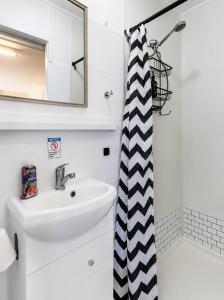 a bathroom with a sink and a shower at Murray Bridge Riverview cabin in Murray Bridge