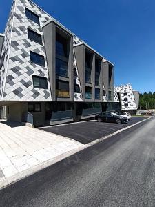 a car parked in a parking lot next to a building at Virgin Forest D&A in Gornja Presjenica