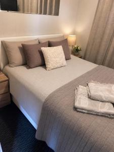 a bedroom with a large bed with a white bedspread at Murray Bridge Riverview cabin in Murray Bridge