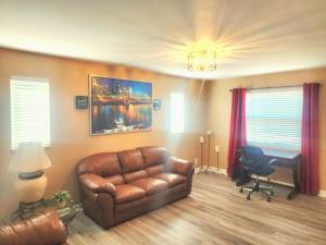a living room with a leather couch and a desk at 513Company - Hometown +Location in Cincinnati