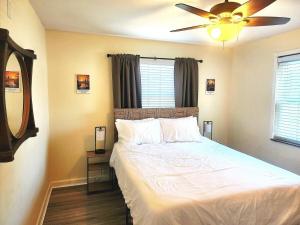 a bedroom with a bed with a ceiling fan at 513Company - Hometown +Location in Cincinnati