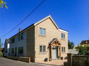 a brick house with an open door on a street at Cern-Wyn in Chippenham