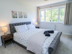a bedroom with a large bed and a window at Cern-Wyn in Chippenham