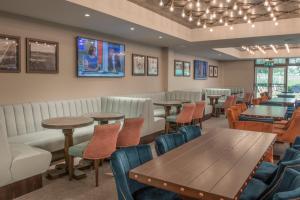 a restaurant with tables and chairs and a couch at De Vere Wokefield Estate in Reading
