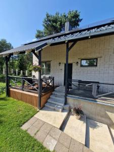 a house with a porch and a patio at Vila Varėna in Varėna +6 photos