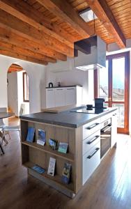 a large kitchen with a counter top in a room at Casa Il Nido Bright Rooftop Nest in Lecco