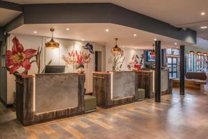 a lobby with a bar with flowers on the wall at De Vere Wokefield Estate in Reading +58 photos