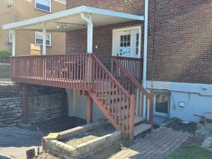 a wooden staircase leading into a brick house at 513Company - Sanctuary in Cincinnati