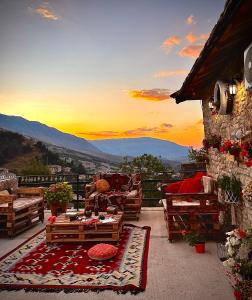 a balcony with a table and a view of the mountains at Golden Guest House in Gjirokastër