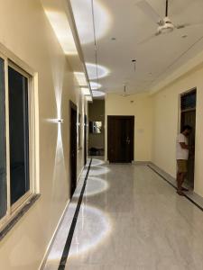 a hallway with a man standing in the middle of a room at Hotel New Vedas Villa 15 mints From Ram Temple in Ayodhya