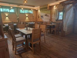 a dining room with wooden tables and chairs at Popp`n Angerl in Tauplitz