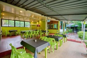a restaurant with tables and chairs in a room at Treebo Lands End Beach Resort - 100m From Morjim Beach in Morjim