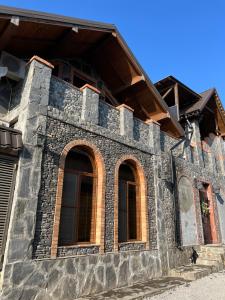 a stone building with windows on the side of it at QahramanoffsChalet in Gabala