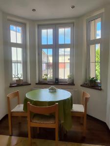 a dining room with a table and chairs and windows at Młyn Warmiński -Hotelik Hermes in Pieniężno