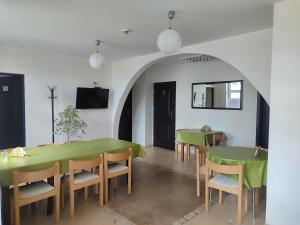 a dining room with a green table and chairs at Młyn Warmiński -Hotelik Hermes in Pieniężno