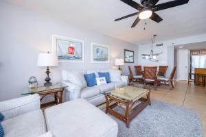 a living room with a couch and a table at Phoenix VII 7709 condo in Orange Beach