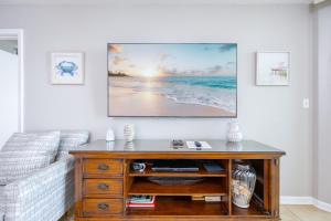 a living room with a tv on a wall at Phoenix VII 7709 condo in Orange Beach +49 photos