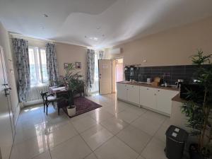 a kitchen with white cabinets and plants in it at Casa Aurora in Ravenna