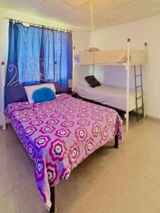 a bedroom with a bed and bunk beds in it at Beachside Cabana with Pool & Beach Access in Nueva Gorgona