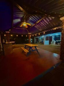 a picnic table in the middle of a building at Beachside Cabana with Pool & Beach Access in Nueva Gorgona