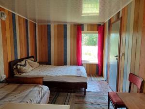 a small bedroom with a bed and a window at BurshtynSV in Svityazʼ