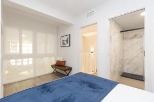 a bedroom with a bed and a chair at Xena Cucuraza by BeValle in Panticosa