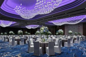 a banquet hall with white tables and chairs and purple ceilings at Hong Kong Ocean Park Marriott Hotel in Hong Kong +84 photos