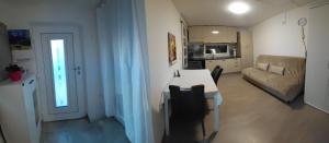 a living room with a table and a couch at Apartma Sonček in Šentjur