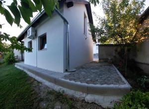 a white building with a walkway next to it at Apartma Sonček in Šentjur