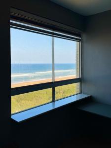 a window in a room with a view of the ocean at Afsaal 612 in Amanzimtoti