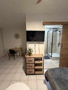 a room with a bedroom with a desk and a table at Saint-Pierre Studio in Avignon +12 photos