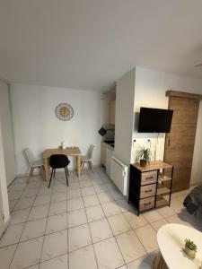 a living room with a kitchen and a table and a room at Saint-Pierre Studio in Avignon