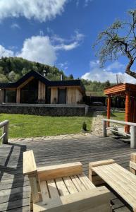 a wooden bench in front of a house at Mountain villa in Skhidnitsa