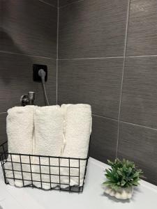 a towel rack with three towels on a bathroom counter at Apartment Lunette in Mostar