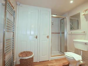 a bathroom with a shower and a toilet and a sink at Vis Valley View in Pentewan +27 photos