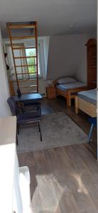 a bedroom with two beds and a table and a ladder at Ferienwohnung Kirschbaumblick in Ettringen