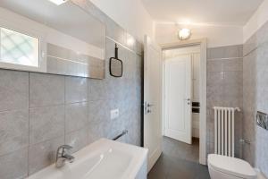a bathroom with a white sink and a toilet at Villa Capo Berta View in Diano Marina +29 photos