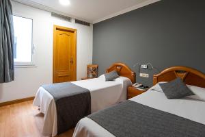 Postel nebo postele na pokoji v ubytování Iraipe Izaga Hostal