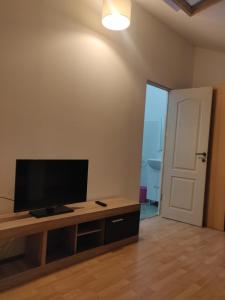 a living room with a flat screen tv on a table at Enjoy strudio apartment M in Murfatlar