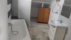a bathroom with a white tub and a sink at Enjoy strudio apartment M in Murfatlar