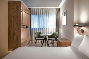a hotel room with a bed and a table and chairs at AC Hotel Atocha by Marriott in Madrid +79 photos
