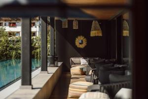 a restaurant with chairs and a swimming pool at Boutique Hotel Das Rivus in Leogang