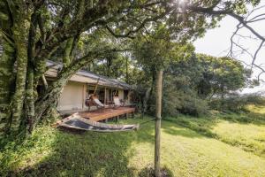 a hammock in front of a house at Elephant Pepper Camp in Masai Mara +36 photos